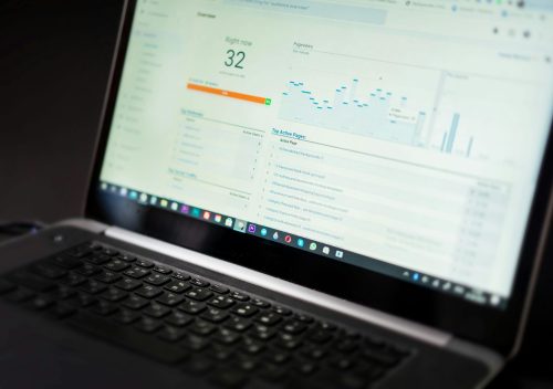 A laptop displaying an analytics dashboard with real-time data tracking and analysis tools.